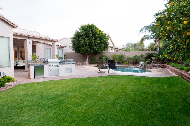 Exploring the advantages of green building in a sustainable backyard environment with a pool and patio for relaxation