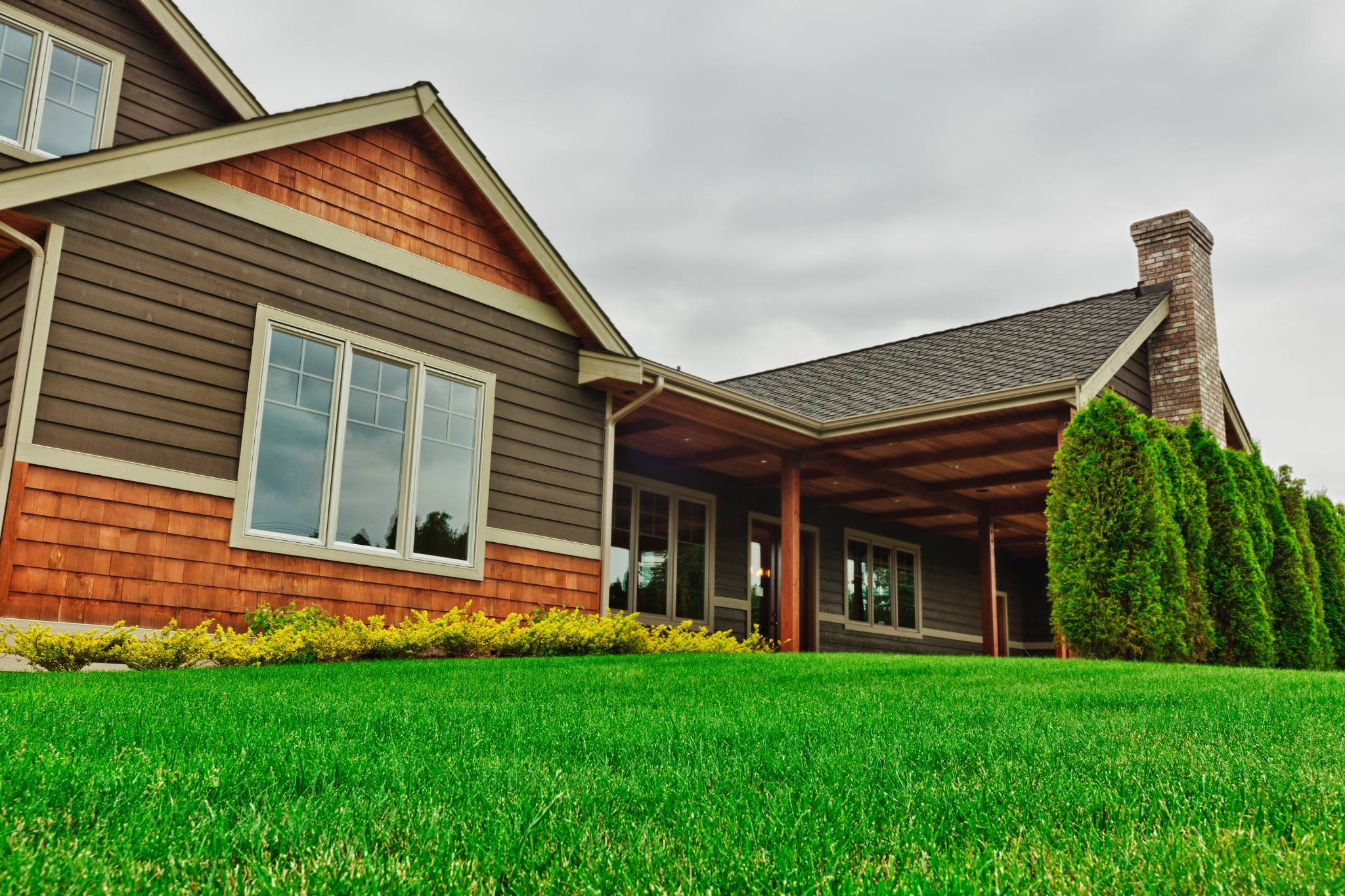 Custom home contractors showcasing a beautifully designed house with detailed craftsmanship and landscaping