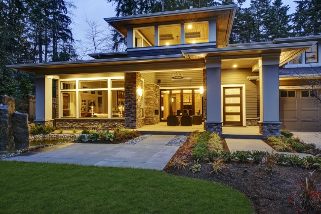 Beautifully designed new construction home at dusk showcasing modern architecture and inviting landscape