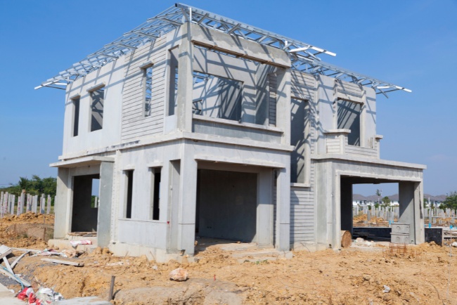 Newly constructed residential building showcasing modern architectural design in an emerging neighborhood with clear blue sky