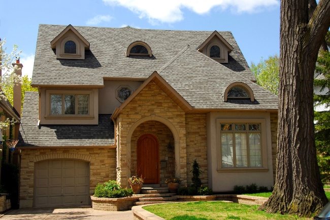 Beautiful residential home showcasing modern design and elegant stonework in a serene neighborhood setting