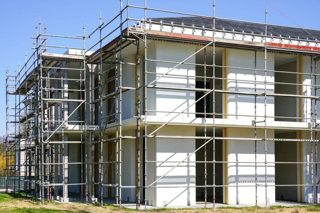 Sustainable commercial construction project showcasing scaffolding and energy-efficient design in progress during daylight