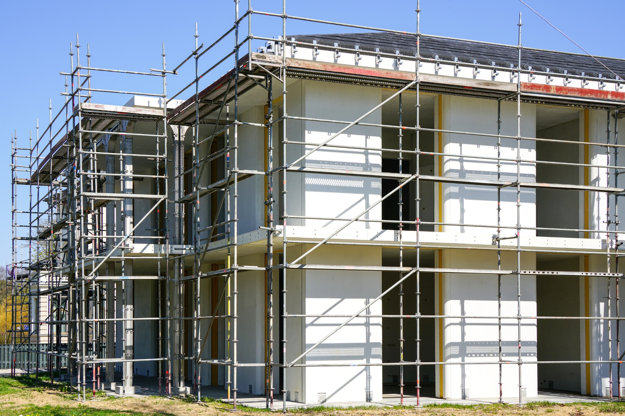 Sustainable commercial construction project showcasing scaffolding and energy-efficient design in progress during daylight